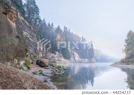 Autumn landscape and red stone cliff of Gauja river, Latvia, Europe. Autumn landscape and red stone cliff of Gauja river, Latvia, Europe. 44834237