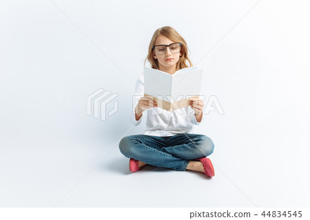 Little modern girl with glasses reading Little modern girl with glasses reading 44834545