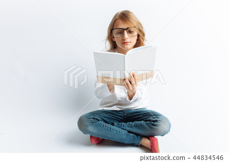 Little modern girl with glasses reading Little modern girl with glasses reading 44834546