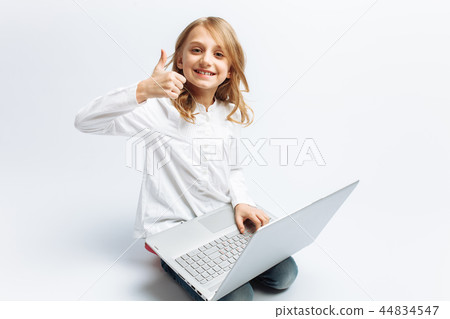 Little modern girl sitting with laptop Little modern girl sitting with laptop 44834547