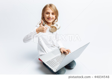 Little modern girl sitting with laptop 44834548