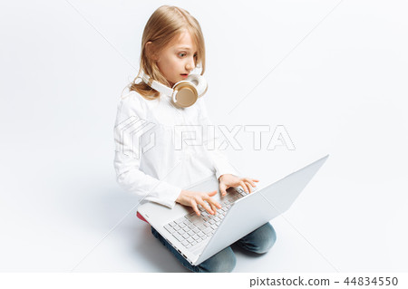 Little modern girl sitting with laptop Little modern girl sitting with laptop 44834550