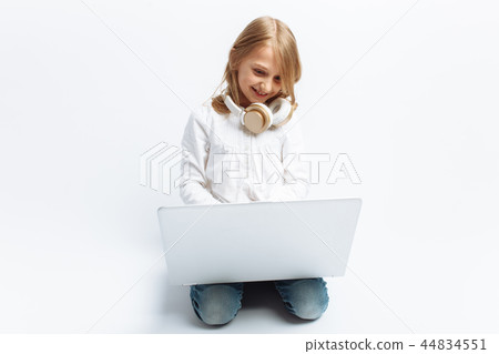 Little modern girl sitting with laptop Little modern girl sitting with laptop 44834551