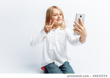 Beautiful teen girl doing selfie on phone 44834554