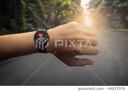 runner checking at heart rate monitor smart watch 44837076