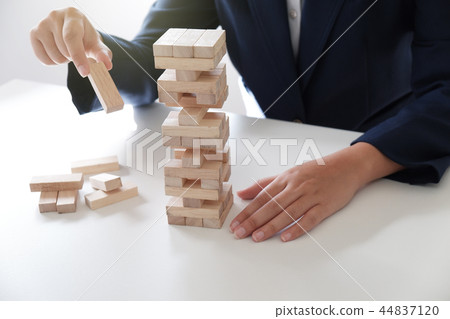 Women place wood blocks symbol of business growth Women place wood blocks symbol of business growth 44837120