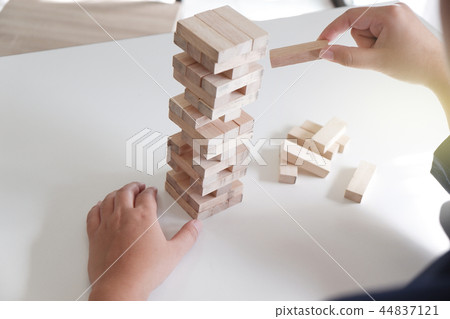 Women place wood blocks symbol of business growth Women place wood blocks symbol of business growth 44837121