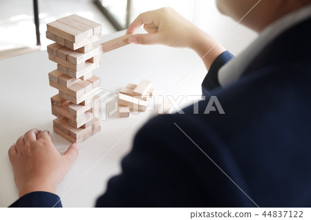 Women place wood blocks symbol of business growth Women place wood blocks symbol of business growth 44837122