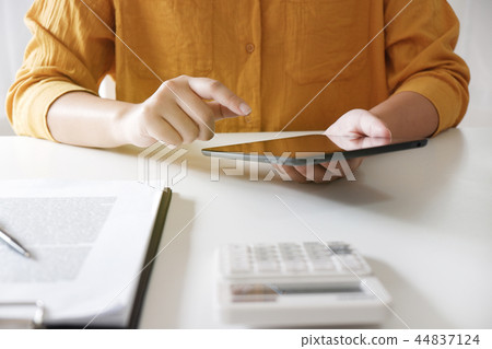 Women using tablet while working in her office. 44837124
