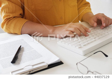 Close-up women hand while typing in office. Close-up women hand while typing in office. 44837129