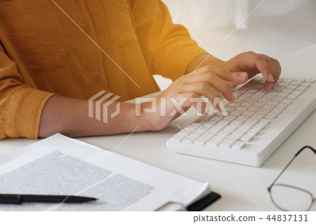 Close-up women hand while typing in office. Close-up women hand while typing in office. 44837131