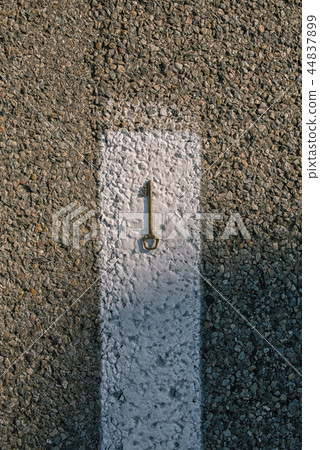 Old vintage brass door Key on asphalt road Old vintage brass door Key on asphalt road 44837899