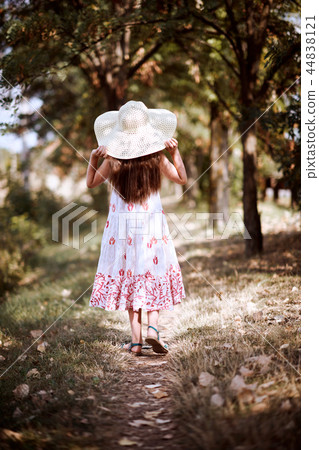 a girl walks along a forest path a girl walks along a forest path 44838121