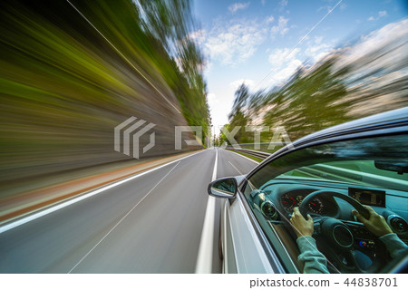 Car in motion blur driving in the Mountains Car in motion blur driving in the Mountains 44838701