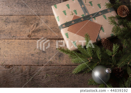 Christmas tree branches and gift on a table 44839192