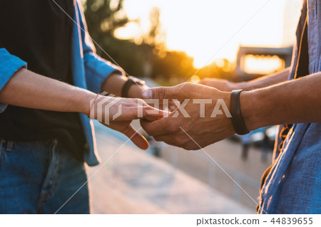 Lovely young hipster couple dating during summer sunset. 44839655