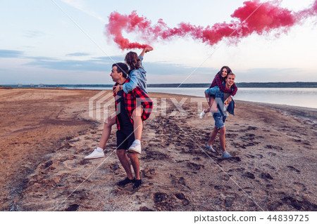 young friends running with hand flare or fusee young friends running with hand flare or fusee 44839725