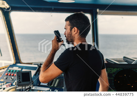 Marine navigational officer is reporting by VHF radio Marine navigational officer is reporting by VHF radio 44839775