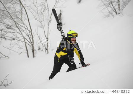 Skier walks in the mountains Skier walks in the mountains 44840232