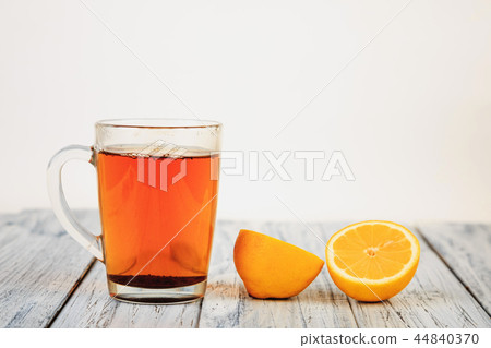 tea and lemon halves on wooden table tea and lemon halves on wooden table 44840370