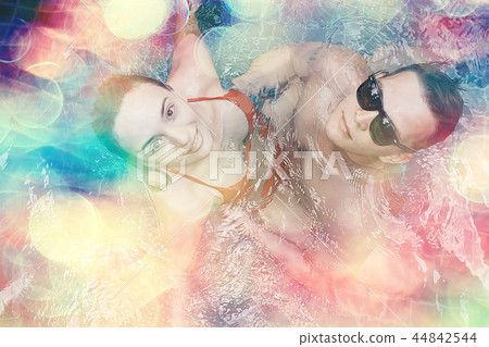 friends have fun in the summer pool at the hotel / cheerful company of young friends of men and women in summer swim in the pool on vacation hotel 44842544