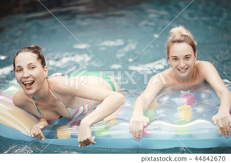 pool girl hotel / summer vacation at the hotel, beautiful young adult girl resting and enjoying the splashes at the pool in the hotel 44842670