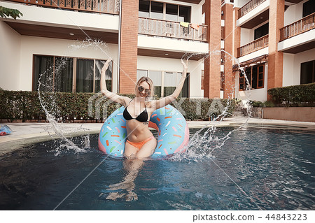 pool girl hotel / summer vacation at the hotel, beautiful young adult girl resting and enjoying the splashes at the pool in the hotel pool girl hotel / summer vacation at the hotel, beautiful young adult girl resting and enjoying the splashes at the pool in the hotel 44843223