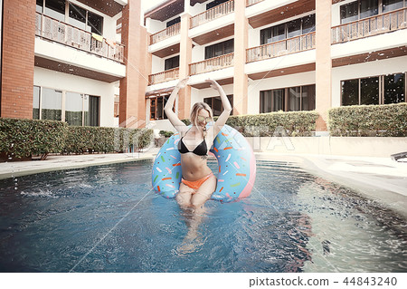 pool girl hotel / summer vacation at the hotel, beautiful young adult girl resting and enjoying the splashes at the pool in the hotel pool girl hotel / summer vacation at the hotel, beautiful young adult girl resting and enjoying the splashes at the pool in the hotel 44843240