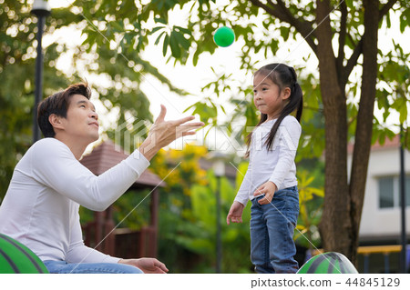 Young family with little girl having fun in park. 44845129