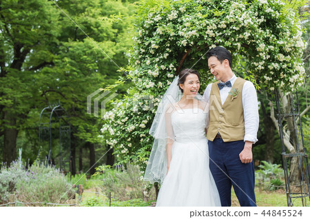 bride and groom smiling in nature 44845524