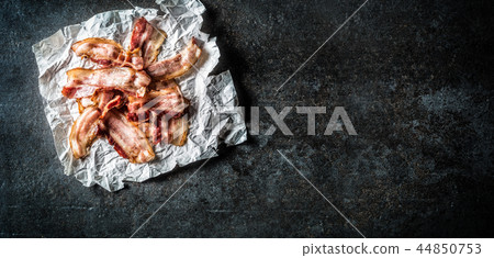 Top of view roasted bacon on paper. Top of view roasted bacon on paper. 44850753