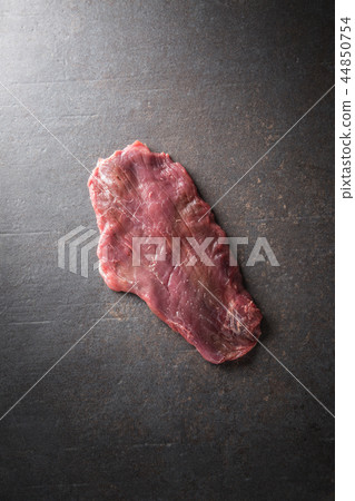 Portion of raw beef flank steak on butcher board Portion of raw beef flank steak on butcher board 44850754