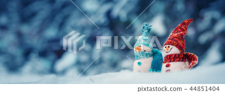 little snowmans on soft snow on blue background little snowmans on soft snow on blue background 44851404