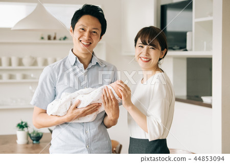 Young couple holding a baby 44853094
