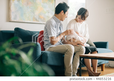 Young couple holding a baby in a room 44853216