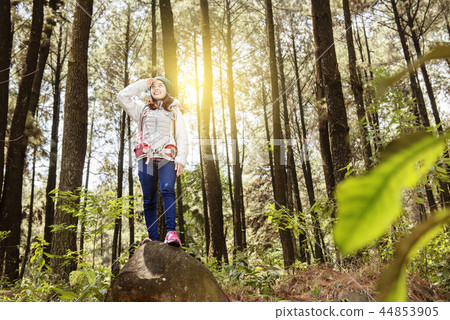 Smiling asian woman standing with backpack 44853905
