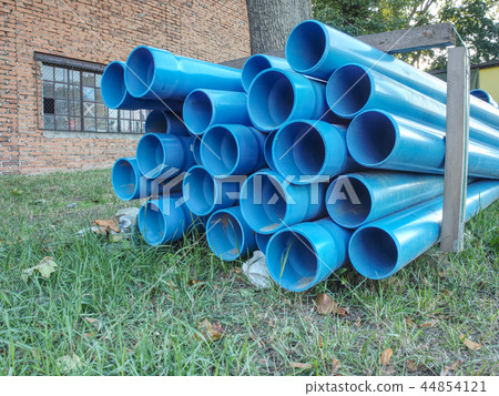 Bundles of blue plastic pipes for water transport 44854121