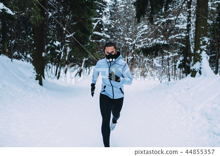 Front view of young sportsman in running mask Front view of young sportsman in running mask 44855357