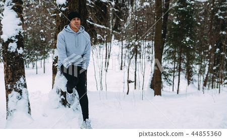 Sportsman relaxing after run at tree 44855360