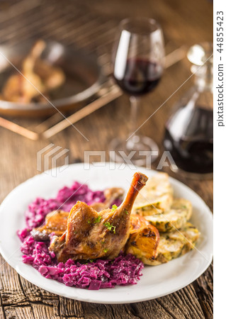 Portion of roast duck leg red and cabbage. Portion of roast duck leg red and cabbage. 44855423
