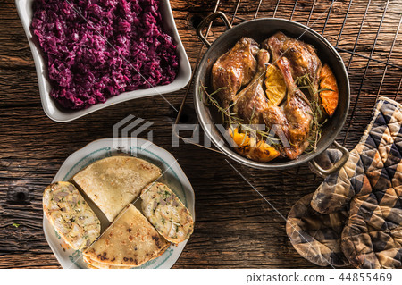 Roasted duck legs in pan with oranges and herbs. Roasted duck legs in pan with oranges and herbs. 44855469