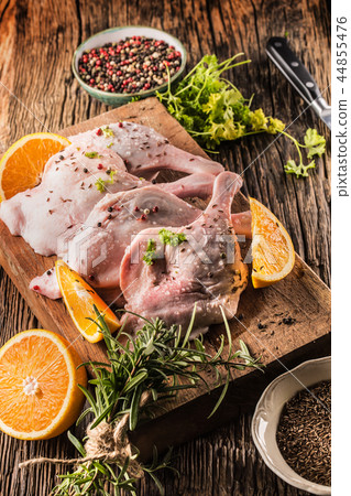 Top of view raw duck legs with oranges and herbs. Top of view raw duck legs with oranges and herbs. 44855476