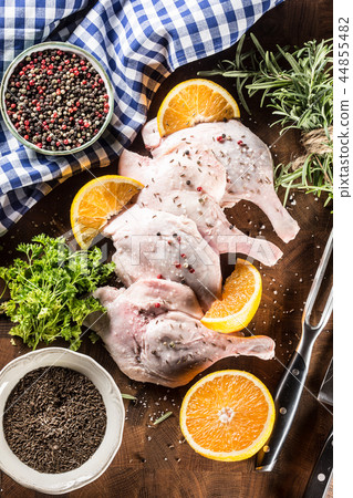 Top of view raw duck legs with oranges and herbs. Top of view raw duck legs with oranges and herbs. 44855482
