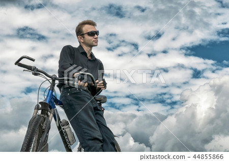 Man stay with bicycle in nature blue sky Man stay with bicycle in nature blue sky 44855866
