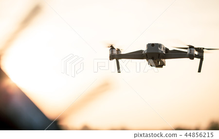 Drone flying during sunset. Drone flying during sunset. 44856215