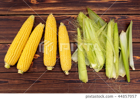 Corn cobs on wooden table. Corn cobs on wooden table. 44857057