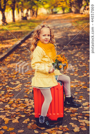 Little girl with blond hair in autumn background 44857869