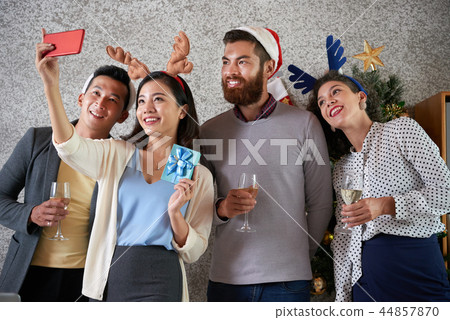 Colleagues taking Christmas selfie 44857870