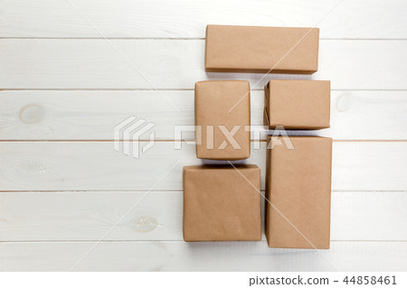 cardboard box on white wooden background cardboard box on white wooden background 44858461