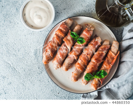 Sausages wrapped in bacon Sausages wrapped in bacon 44860350